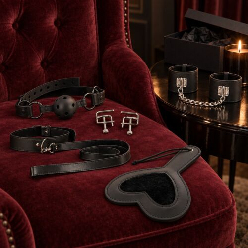 Intermediate BDSM kit with gag, nipple clamps, collar, paddle and cuffs – lifestyle scene (AI-generated image)
