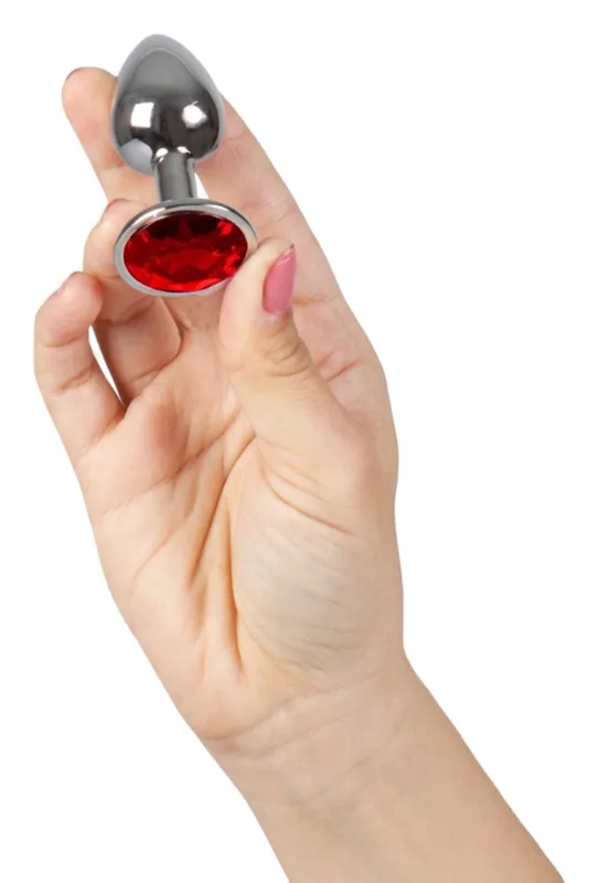 The Secretplay plug with a red jewel, size S, in a hand